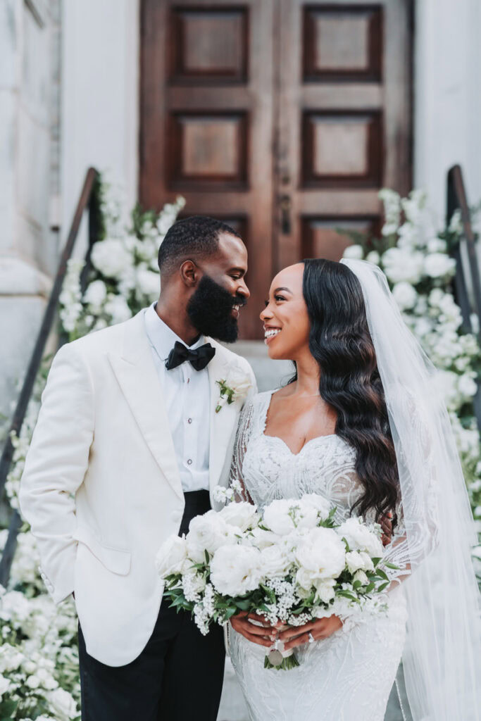 Bride and groom taking wedding portraits outside of dekalb history museum