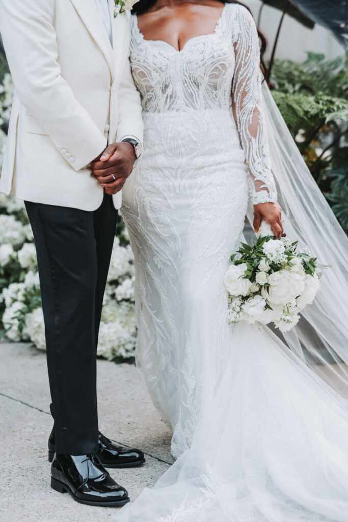 up close photo of bride and groom's wedding attire with bouquet from Blosm Designs